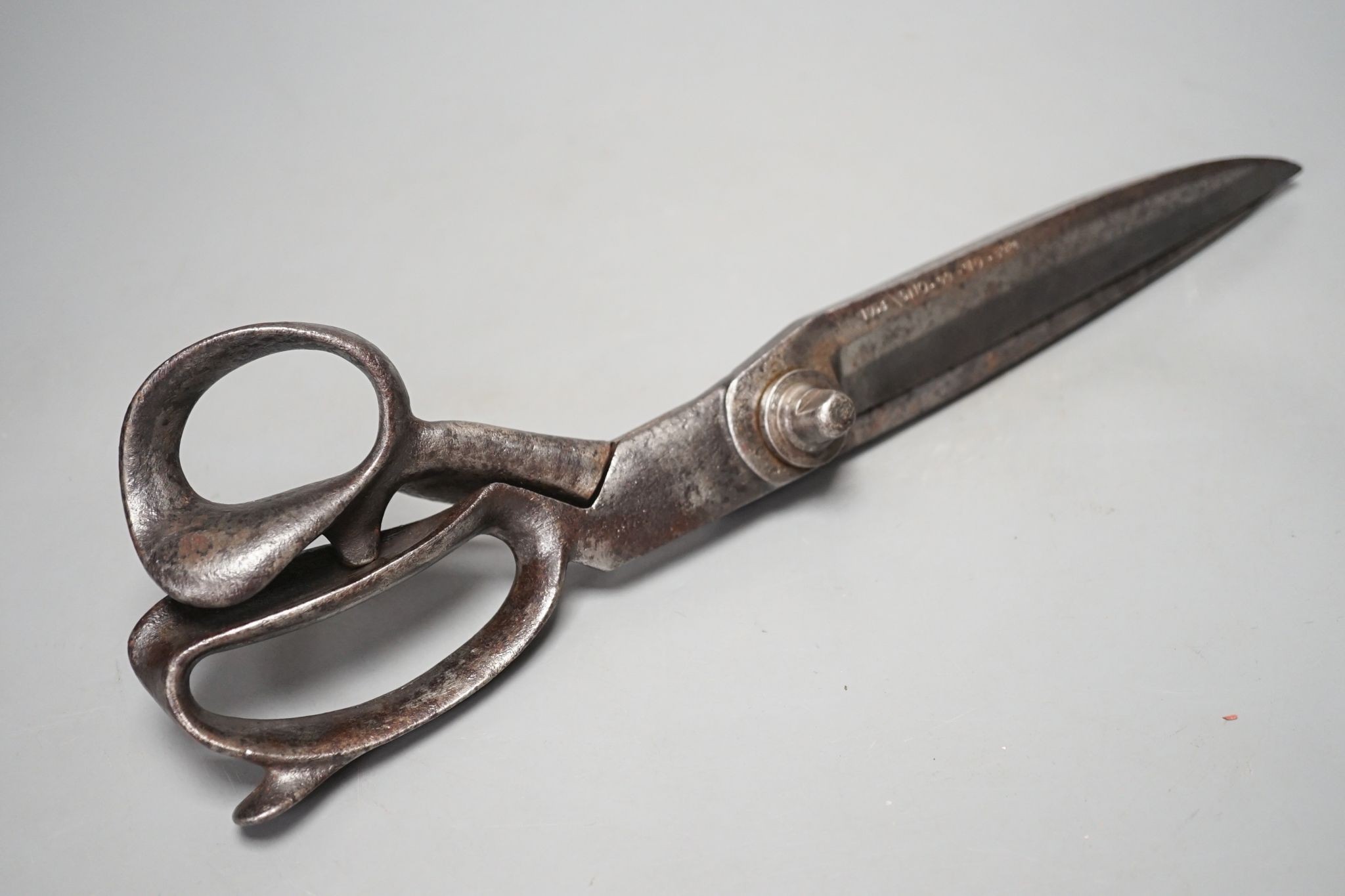 A pair of over-sized tailor’s scissors, one blade stamped ‘1938 \ 5110.99.910.5934’